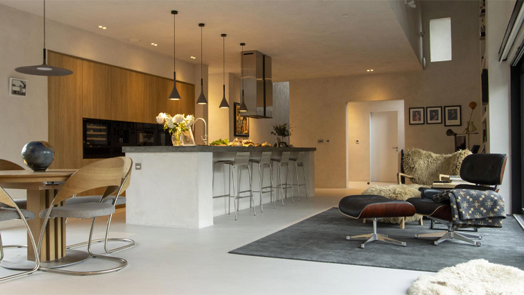 A desert modern kitchen with mid-mod dining chairs and an island