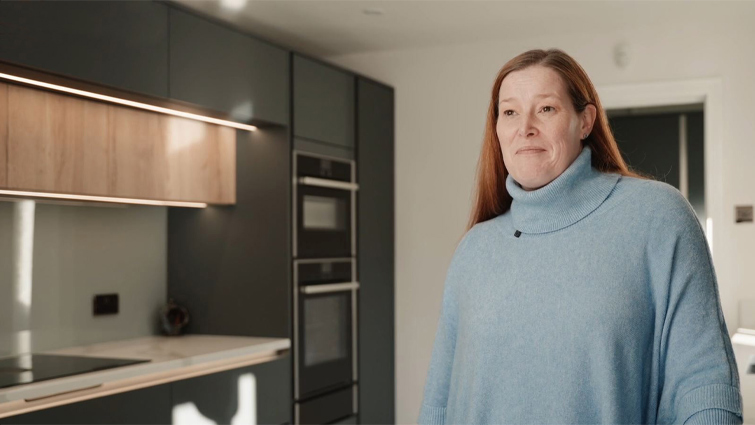 Lisa in her true handleless kitchen contemplating a kitchen extension price