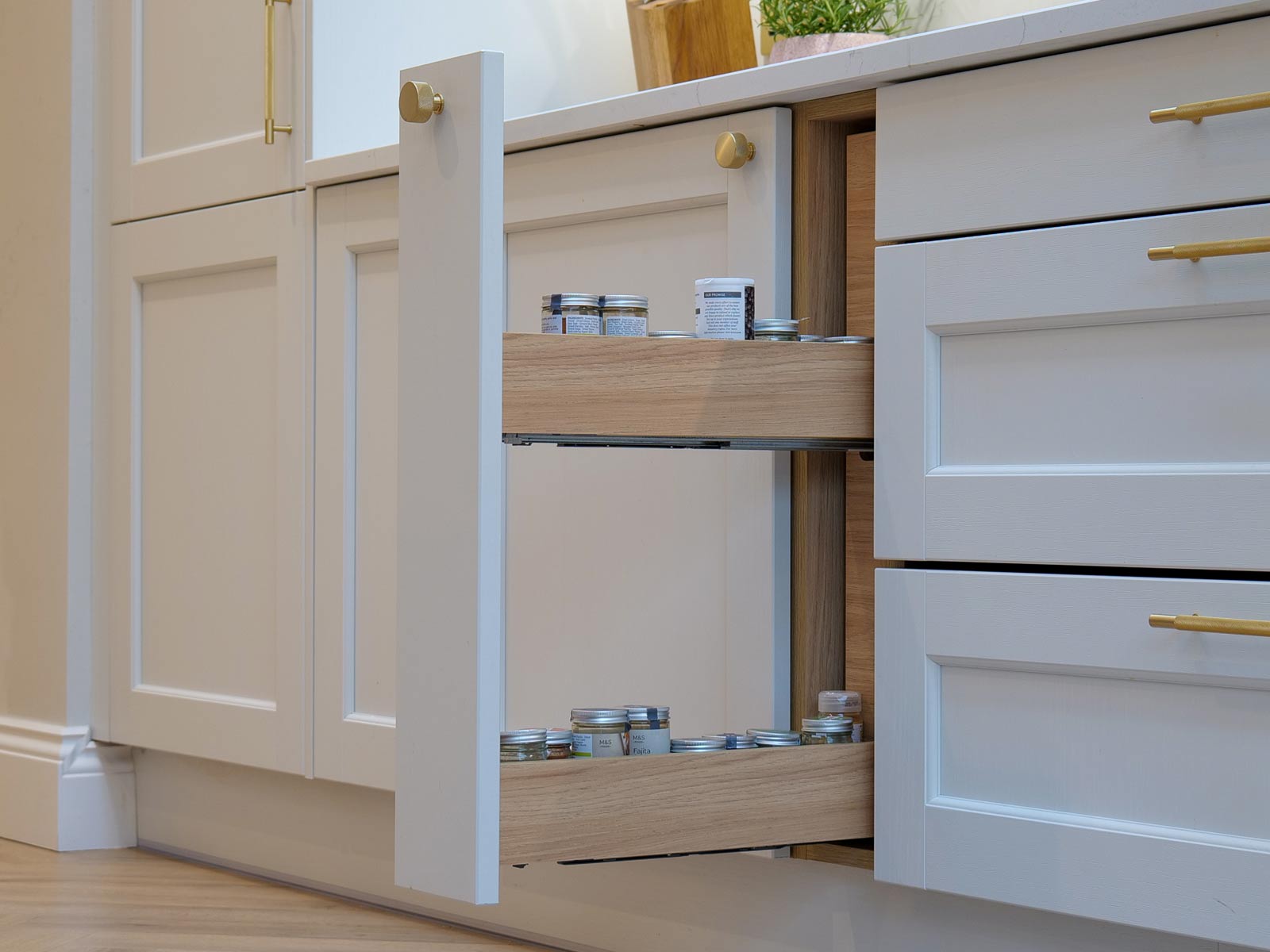 A minimalist design kitchen with a pull-out condiments rack in a minimalist Shaker kitchen