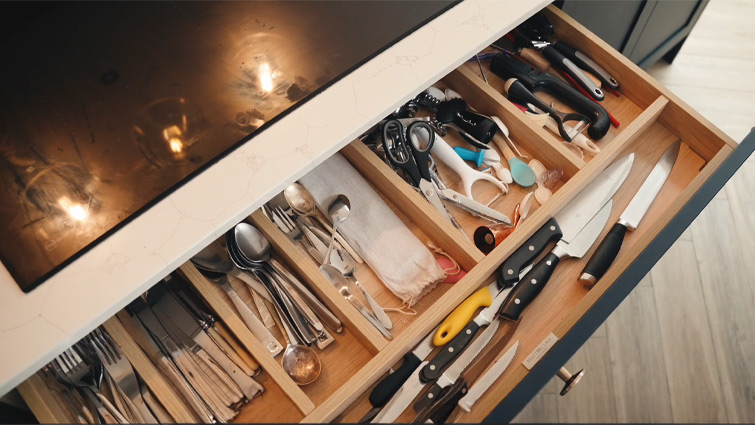 A kitchen cabinet drawer with integrated wood cutlery dividers