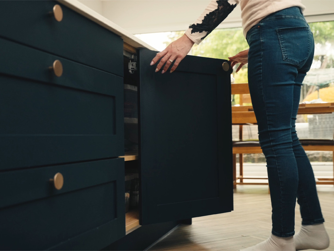 A bi-fold kitchen cabinet door demonstrated by Carlie