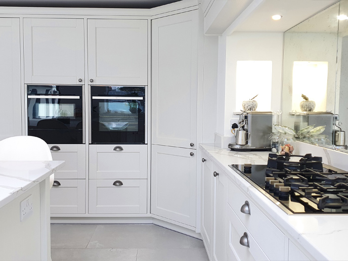 A classic grey kitchen corner larder with surrounding cabinets