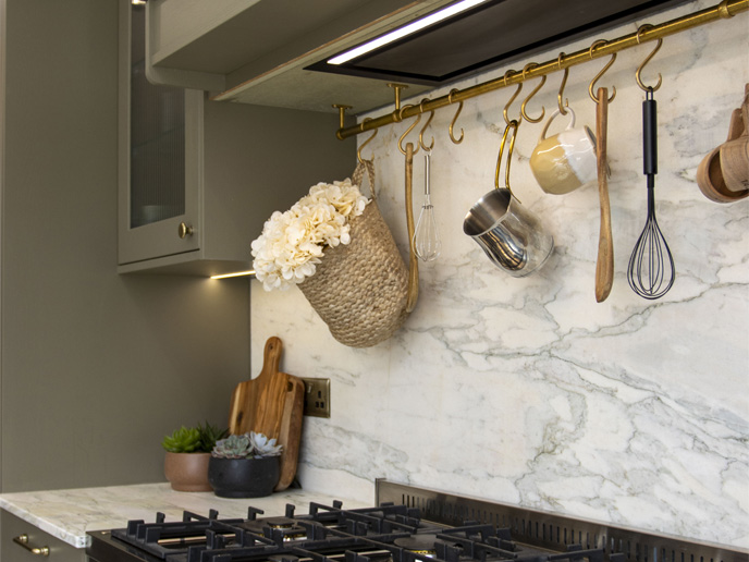 A natural earthy kitchen corner with hanging pots and ladles