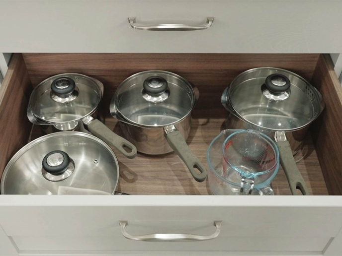 A sub-kitchen countertop storage solution with space for pots and pans