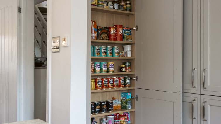 A spice rack cupboard setup that also includes tins