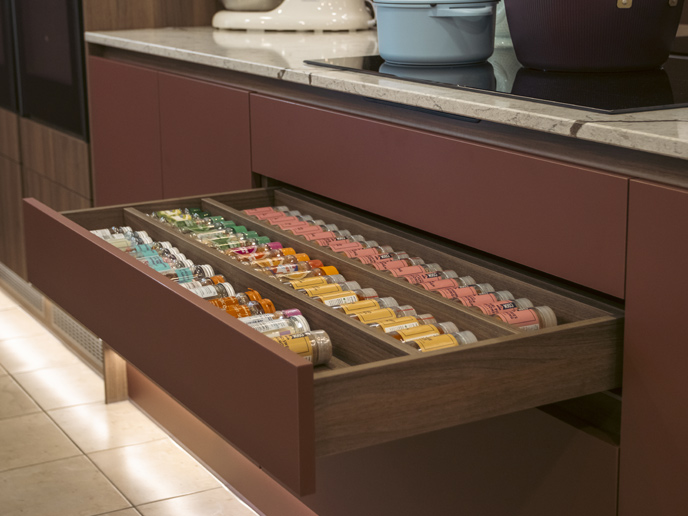 A spice rack drawer insert demonstrating in-drawer spice storage