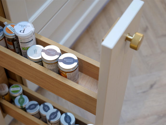 A sliding spice rack for thin cupboards with restricted under-cabinet spice rack space