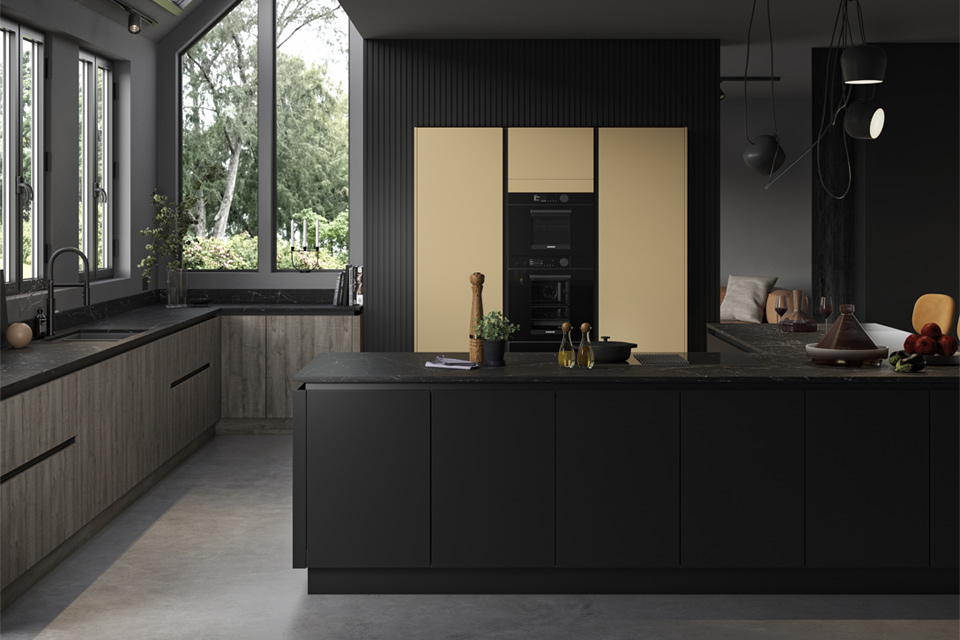 A mustard yellow kitchen with black and wood complementary cabinets