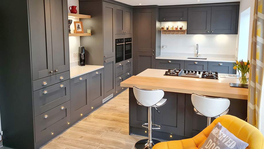 Dark shaker kitchen with breakfast bar in Cardiff