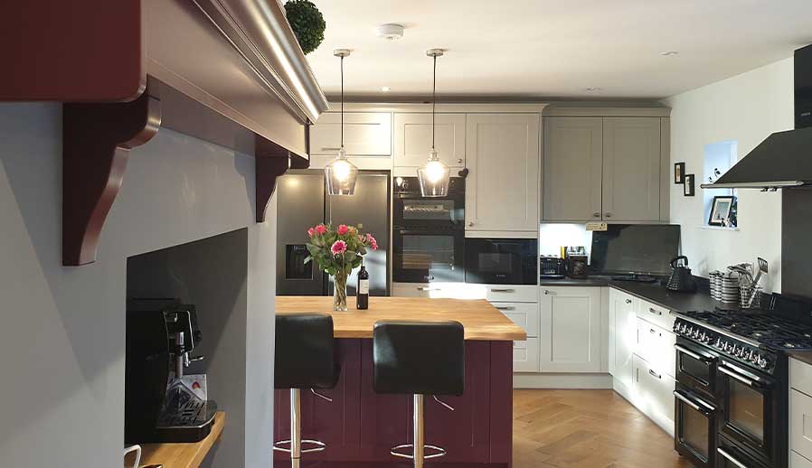 Shaker kitchen with purple kitchen island in Esher