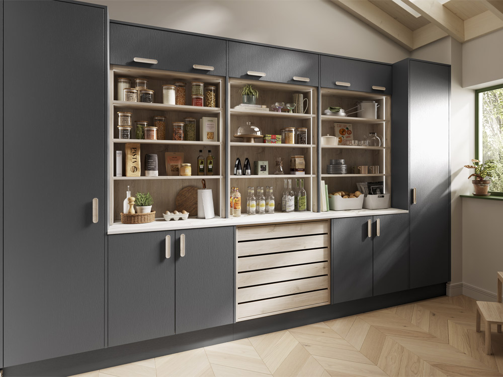 A grey modern kitchen with light wood shelves and crate drawers