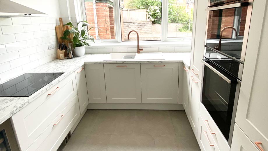 Small kitchen with rose gold handles