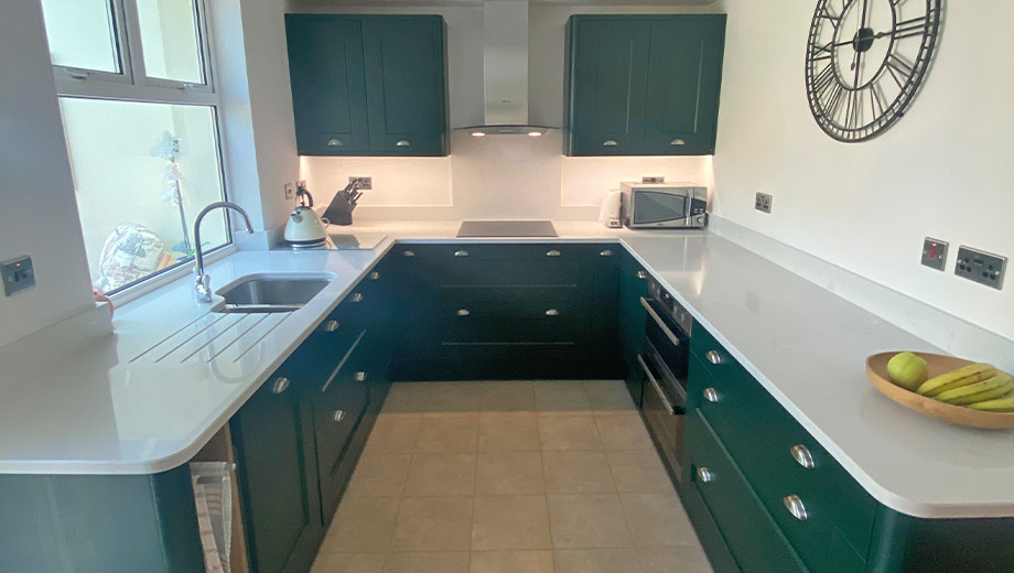 Small kitchen with green cabinetry