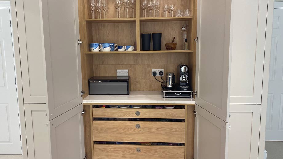 A space-saving kitchen cabinet with coffee station and drawers