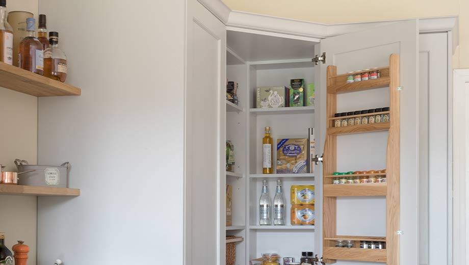Space-saving kitchen corner storage with hanging spice rack