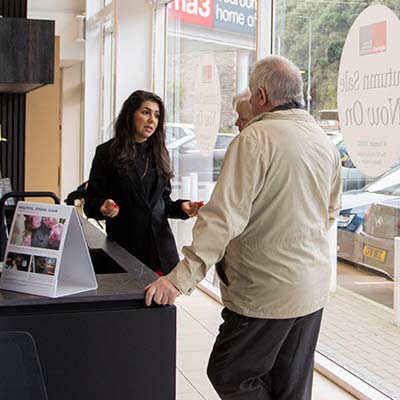 Customers talking to a designer and looking at kitchen displays